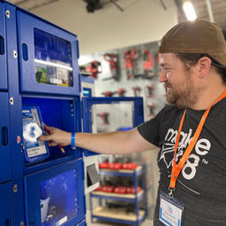 tool tech adam standing in front of the fastenal locker pulling something out of one of the compartments 