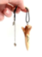 hand crafted ash wood pendulum pendant hanging from hand view
