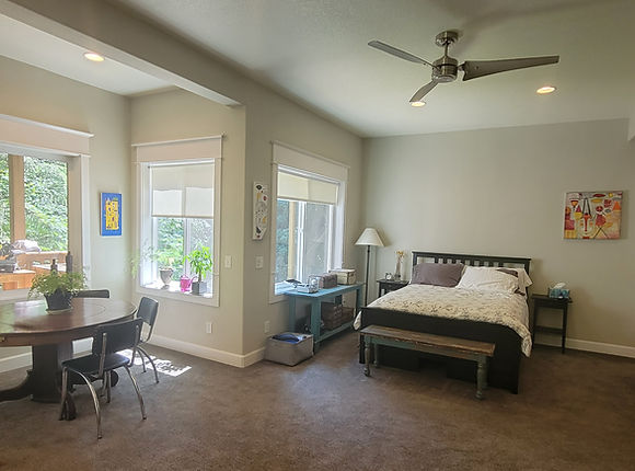 Light-filled room with bed, table, chairs