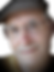 ChristianCogné souriant, portant lunettes et casquette, regardant vers l'avant.