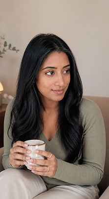 Dr Romila Ragaven, clinical psychologist, sitting thoughtfully with a cup, representing credible expert partnership for brands