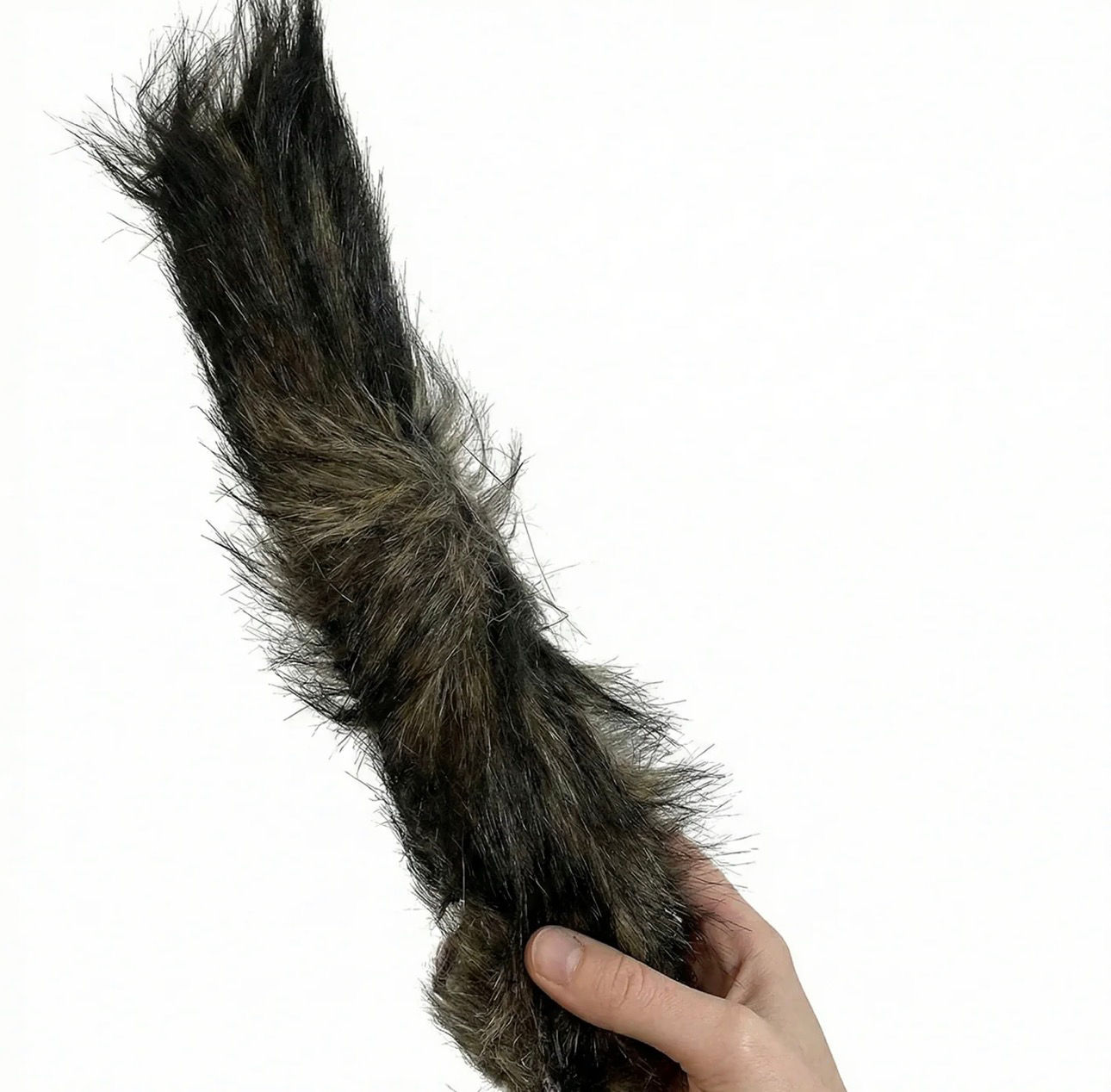 Hand holding furry animal tail