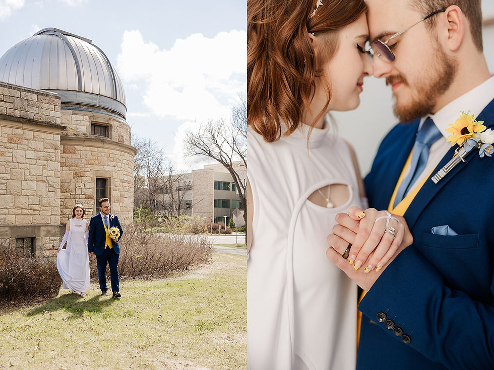 A couple poses in wedding attire; the bride in white holding sunflowers, and the groom in a blue suit. They stand by a stone building, sharing a tender moment.
