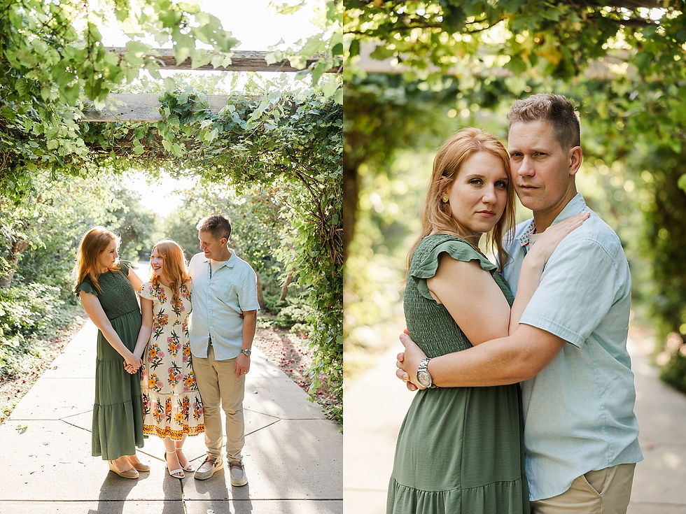 A family of three stands on a sunny path under a leafy arch, smiling and holding hands. The scene is green and serene.