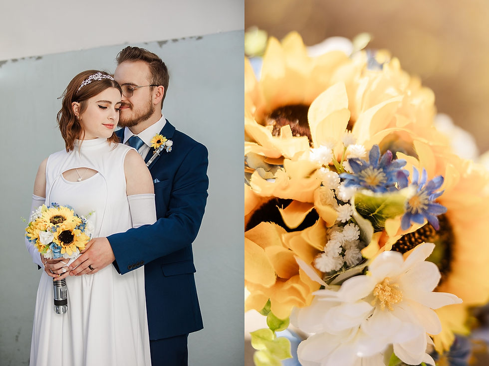 Bride in a white dress and groom in a blue suit holding a vibrant bouquet of sunflowers and blue flowers, sharing an intimate moment.