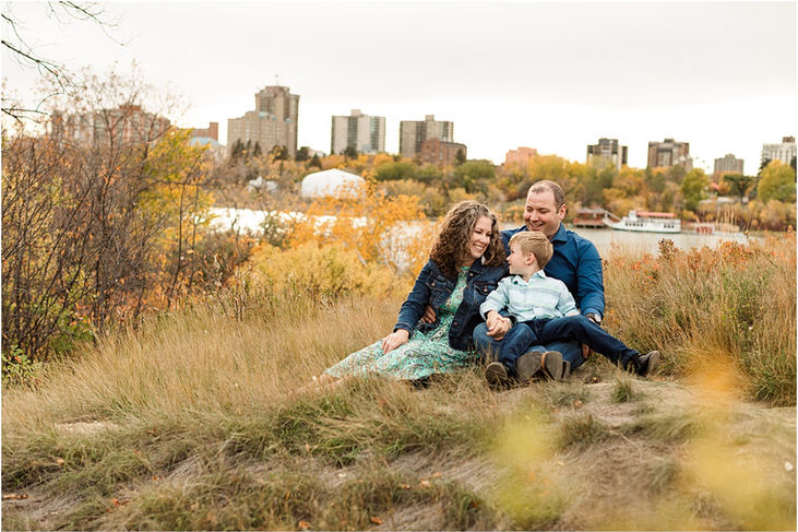 family sitting with river behind