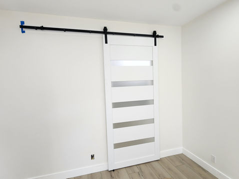 White sliding barn door on a track system.