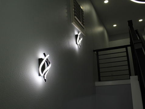 Modern wall lights illuminating a hallway.