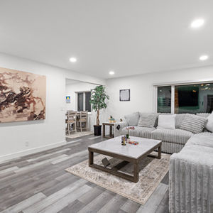 Modern living room with gray furniture and wall art.