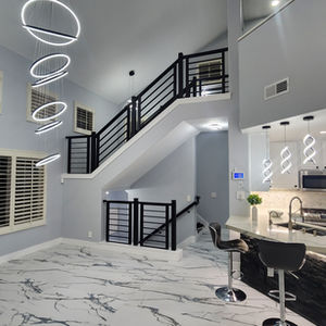 Modern interior with staircase and circular ceiling lights.