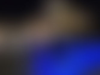 Modern house at night with a white van parked in the driveway, blue accent lights, palm trees, and illuminating stairs. Calm ambiance.