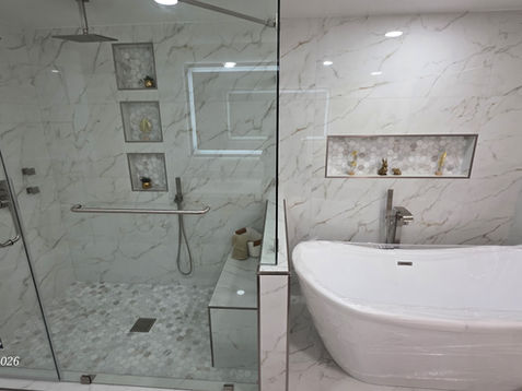 Modern bathroom with marble and freestanding tub.