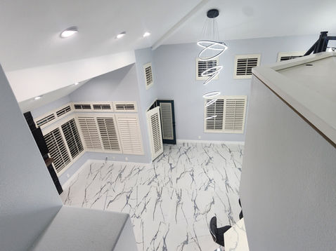 Modern interior with marble floor and contemporary lighting.