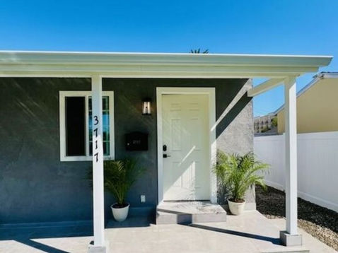 Small modern house with a front porch.