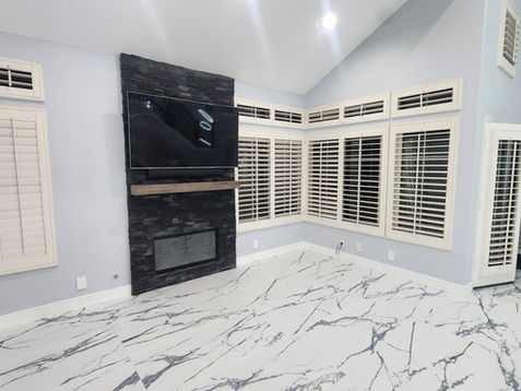 Modern living room with marble floor and fireplace.