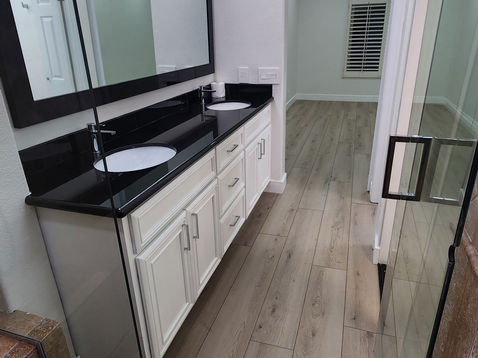 Modern bathroom with sleek vanity and large mirror.