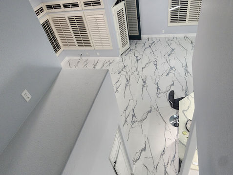 Modern interior with marble flooring and large windows.