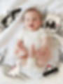 Smiling baby on blanket with elephant, dinosaur, car toys