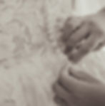 Black-and-white close-up of delicate details during wedding preparations.