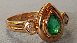 14k gold diamond and pear shaped emerald bezel set ring