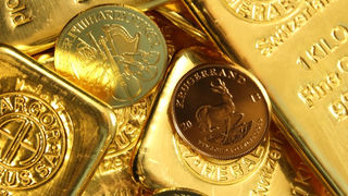a pile of gold bullion consisting of bars and coins