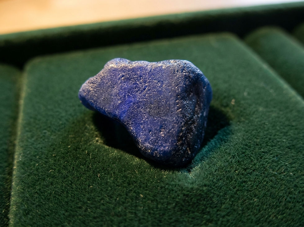 a large cobalt blue piece of sapphire rough that is mostly opaque