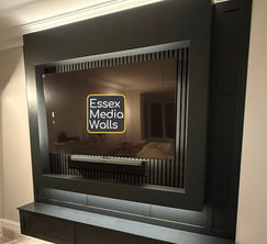 A media wall with TV frame, acoustic slat wall panelling, bespoke floating worktop, tv back lighting.