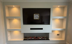 A media wall with shelving with ribbed mdf panelling, led spot lights and Onyx Fusion 150RW Electric Fire in Hockley.