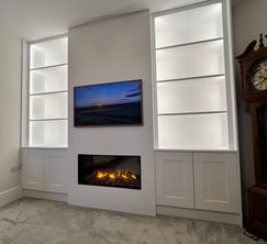 bespoke media wall with a cupboard to the side and a Gazco eReflex 110RW Fire in Witham.