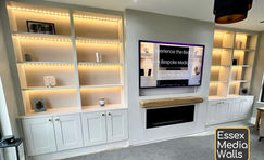 Bespoke Wooden Media Wall with shelving, cupboards, led lighting a bioethanol fire with oak mantel in Wickford.