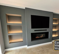 A bespoke media wall with shelving, cupboards, led lighting a Gazco Studio 1 gas fire in Hadleigh.