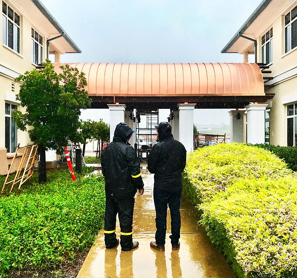 Metal roof installers with copper metallic metal roof