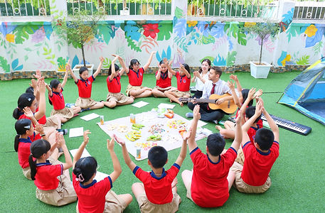Jack teaching some students guitar