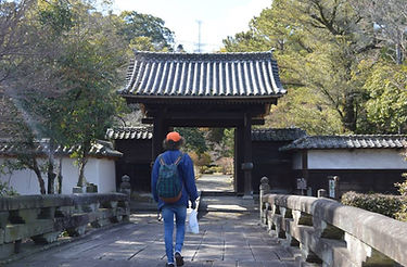Jack walking towards a Japanese temple gate