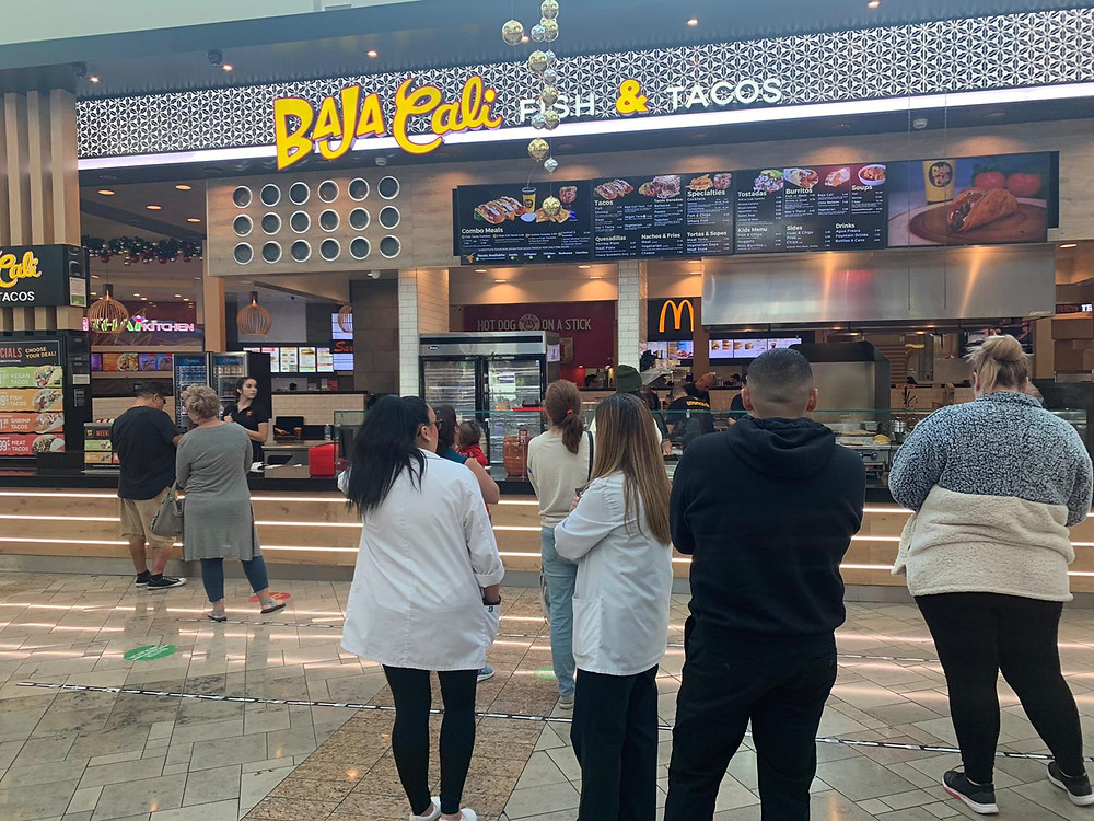 Customers viewing mexican food menu at Baja Cali locatin #7- Santa Anita Mall