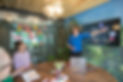 White woman presenting slides in a workshop to two other people.