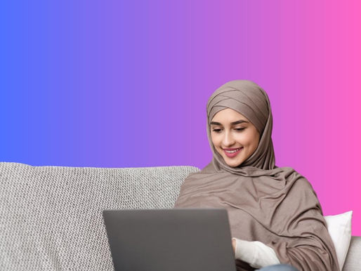 Woman in a hijab smiling while using a laptop on a couch. Background is a gradient of purple to pink, creating a relaxed mood.