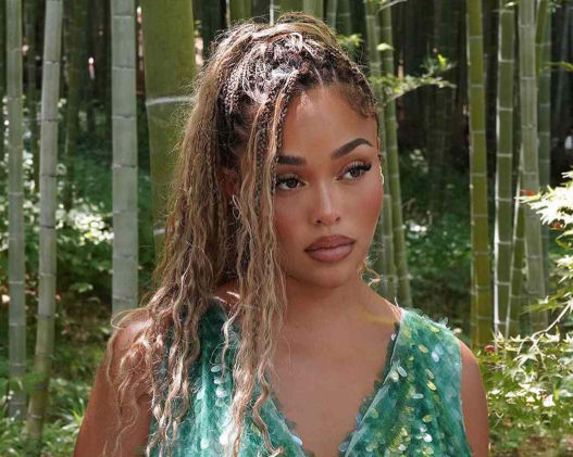 Woman with blonde boho braids ponytail in bamboo forest