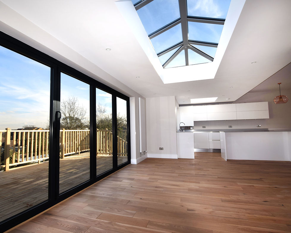 Modern rear house extension in London with roof lantern, sliding glass doors, and open-plan kitchen renovation
