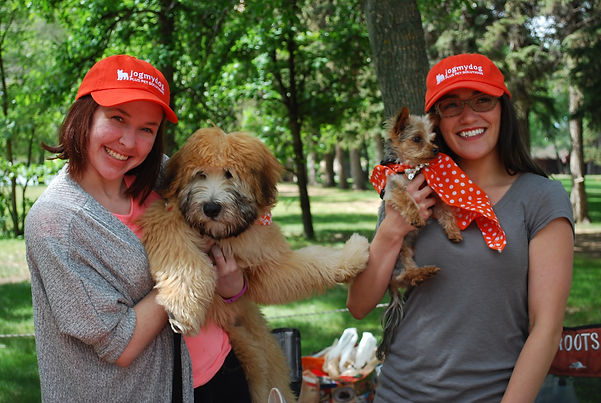 2 pet sitters in Lethbridge holding up puppies in a loving way