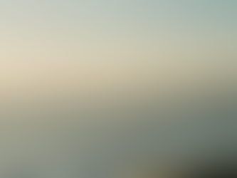 Soft ocean waves rolling toward shore at golden hour