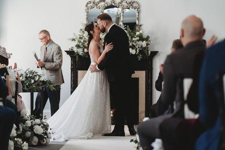 Fifteen Years Together: Jasmine’s Modern, Timeless Wedding at Swynford Manor kiss during ceremony