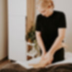 A massage therapist working on a client's calf muscle.