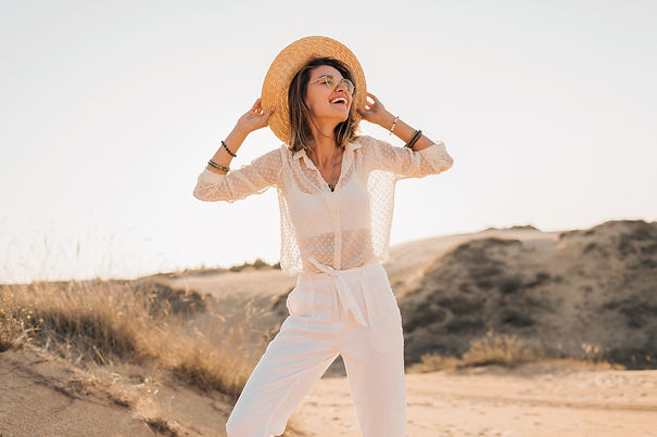 stylish-happy-beautiful-smiling-woman-posing-desert-sand-white-outfit-wearing-straw-hat-su