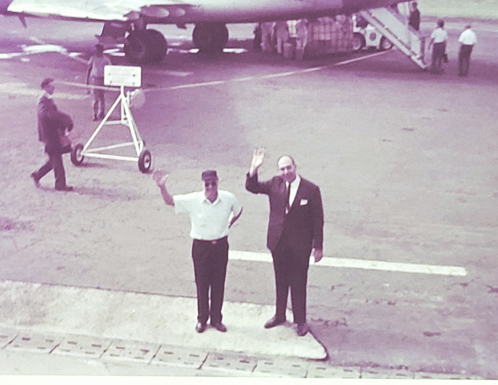 Dad is waving at us from the tarmac