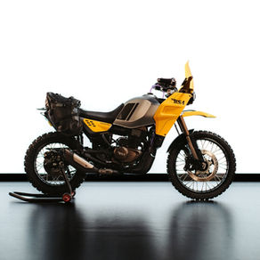 Yellow and black motorcycle on a stand against a white background. Bold "BSA" logo visible. Simple and sleek design.