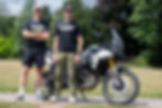 Jonny Walker and Sam Sunderland stand in front of the Triumph Tiger 900 Rally Pro adventure bike.