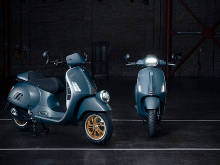 Vespa's new Officina8 special edition scooters in a dark room.