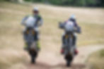Jonny Walker and Sam Sunderland wheelie their Triumph Tiger 900 Rally Pro adventure bikes.