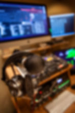 Roots Catering DJ mixer setup focusing on microphone and headset for guest interactions